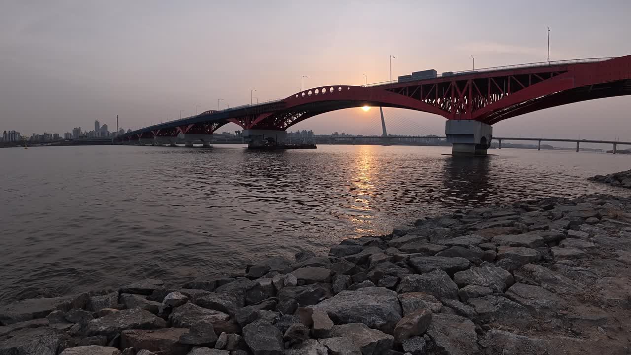 Seongsan Bridge At Dusk - Red Arch Truss Bridge In Seoul Across Han River With Cityscape In Distance. static shot