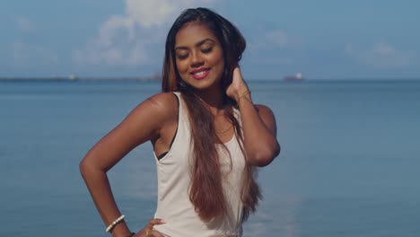 a sunny day on a caribbean beach is the backdrop for a young girl in a beach dress to relish