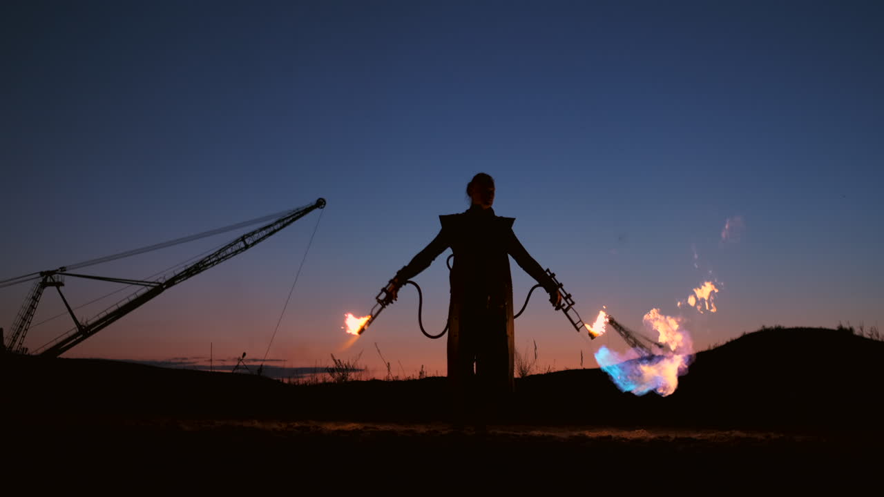 A man with a flamethrower at sunset in slow motion. Costume for zombie Apocalypse and Halloween