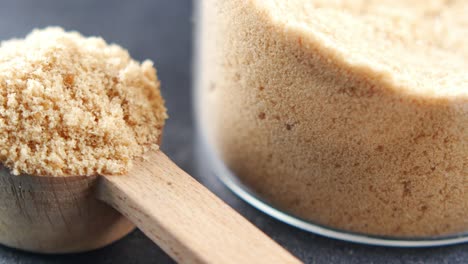 brown sugar in a measuring spoon and jar