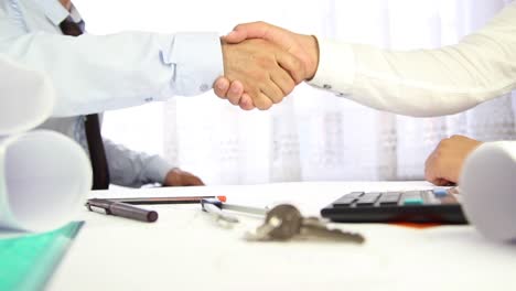 businessman hand shake for selling house