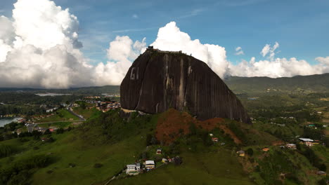 aerial view rising away from the rock of guatapé in sunny antioquia, colombia