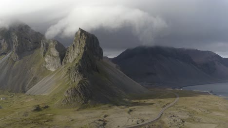 eystrahorn mountain and coast on a cloudy day in iceland - aerial drone shot