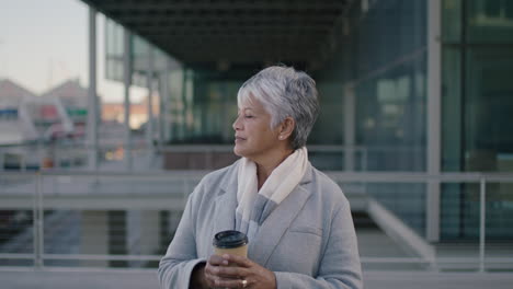portrait portrait mature elegant business woman holding coffee waiting in city corporate education