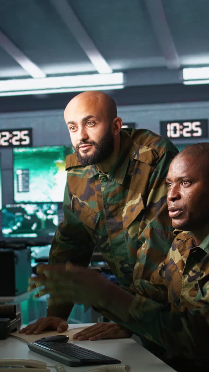 Vertical video Army telecommunications operators inputting data on systems