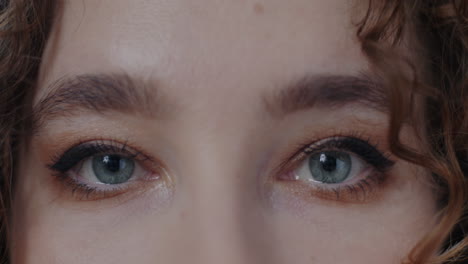 close-up of a woman's face with makeup and curly hair