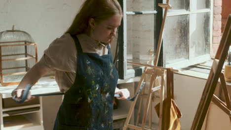 artist putting on apron