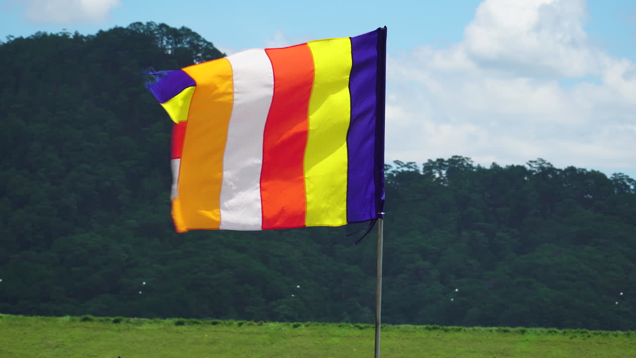 Colourful buddhist flag waving in the wind in Vietnam