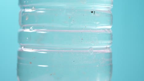 close-up of a plastic water bottle with microplastics