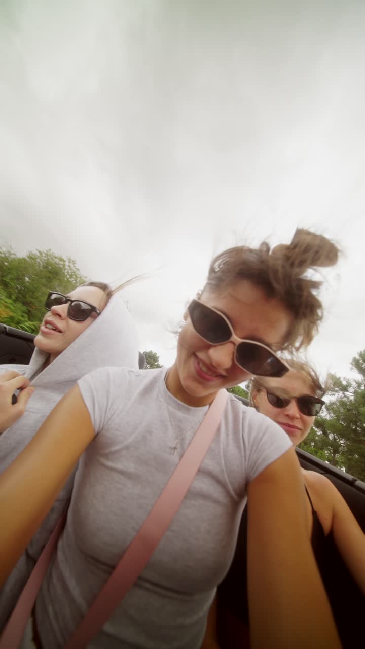 Women having fun on a road trip in a convertible