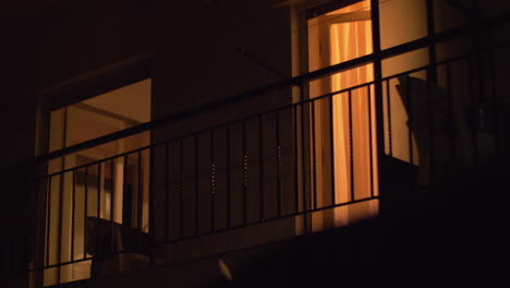 house balcony with open doors at night