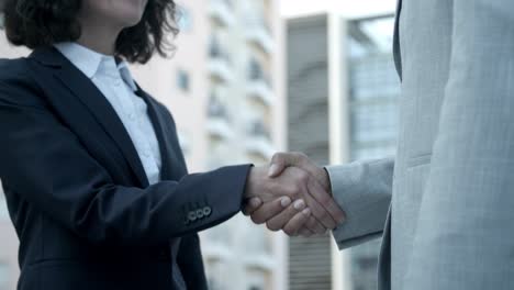 caucasian woman shaking hands with colleague