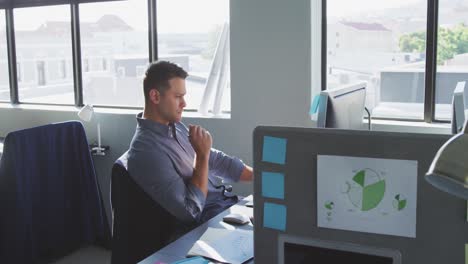 Businessman-looking-away-in-modern-office