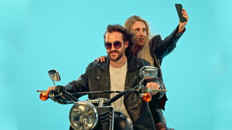 selfie, smile and couple on motorcycle in studio