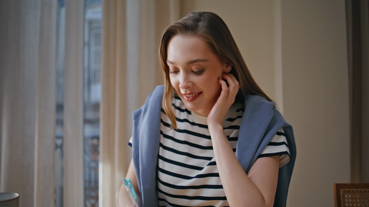 Online student writing homework at home closeup. Smiling woman looking laptop