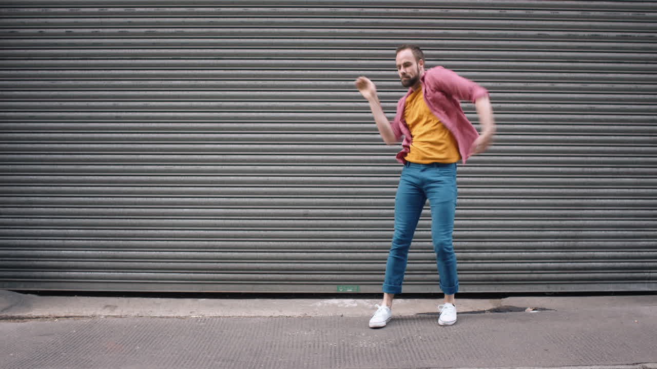 Premium stock video Dance loop funny man dancing in street having fun