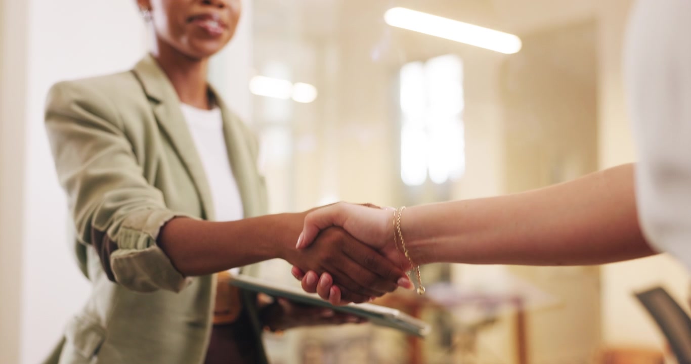 Businesswomen Shaking Hands in Modern Office Setting