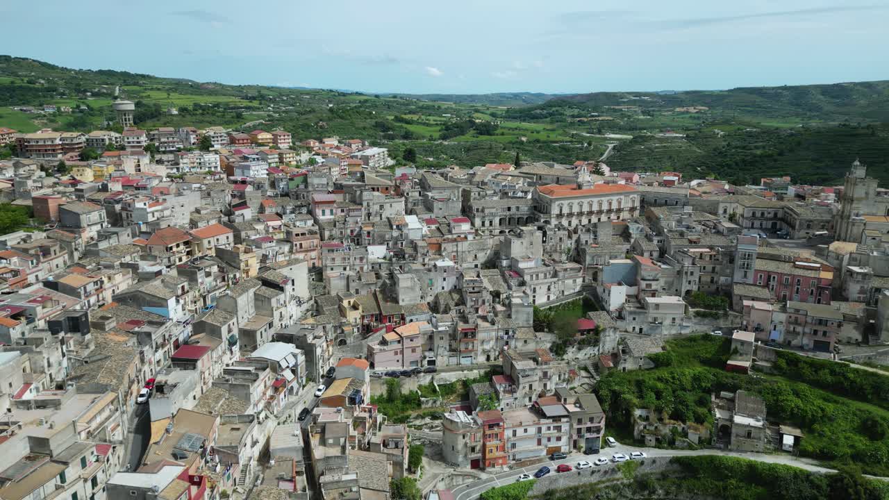 Aerial drone footage of Monterosso Almo, Sicily: ancient hilltop village with stone houses, narrow streets, and surrounding green valleys. Perfect for travel, culture, and documentary projects