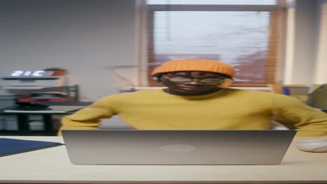 man working on laptop in office