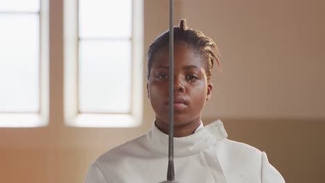 Female-fencer-athlete-during-a-fencing-training-in-a-gym