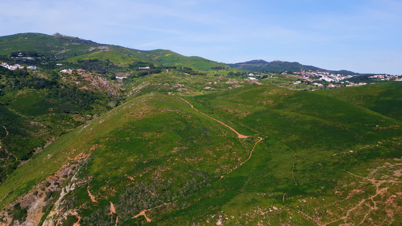 Panoramic view grassy slopes under cloudy sky. Mountain hills covered greenery