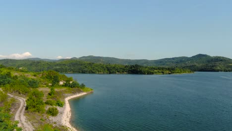 4k aerial drone flight over shoreline of european man made lake