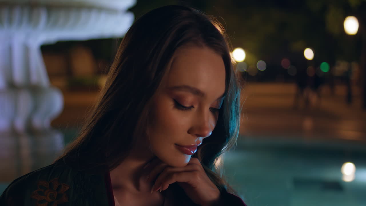 Gorgeous woman posing fountain night city close up. Model standing dark square