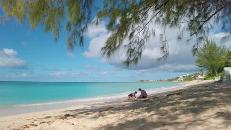 grand cayman, 7 mile beach, tilt to two beachgoers