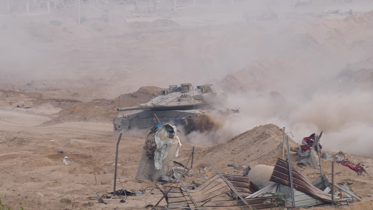 An army battle tank at the border of Gaza, Armoured combat fighting vehicle in destroyed city of Gaza dust during Israel&ndash;Hamas war conflict 2023