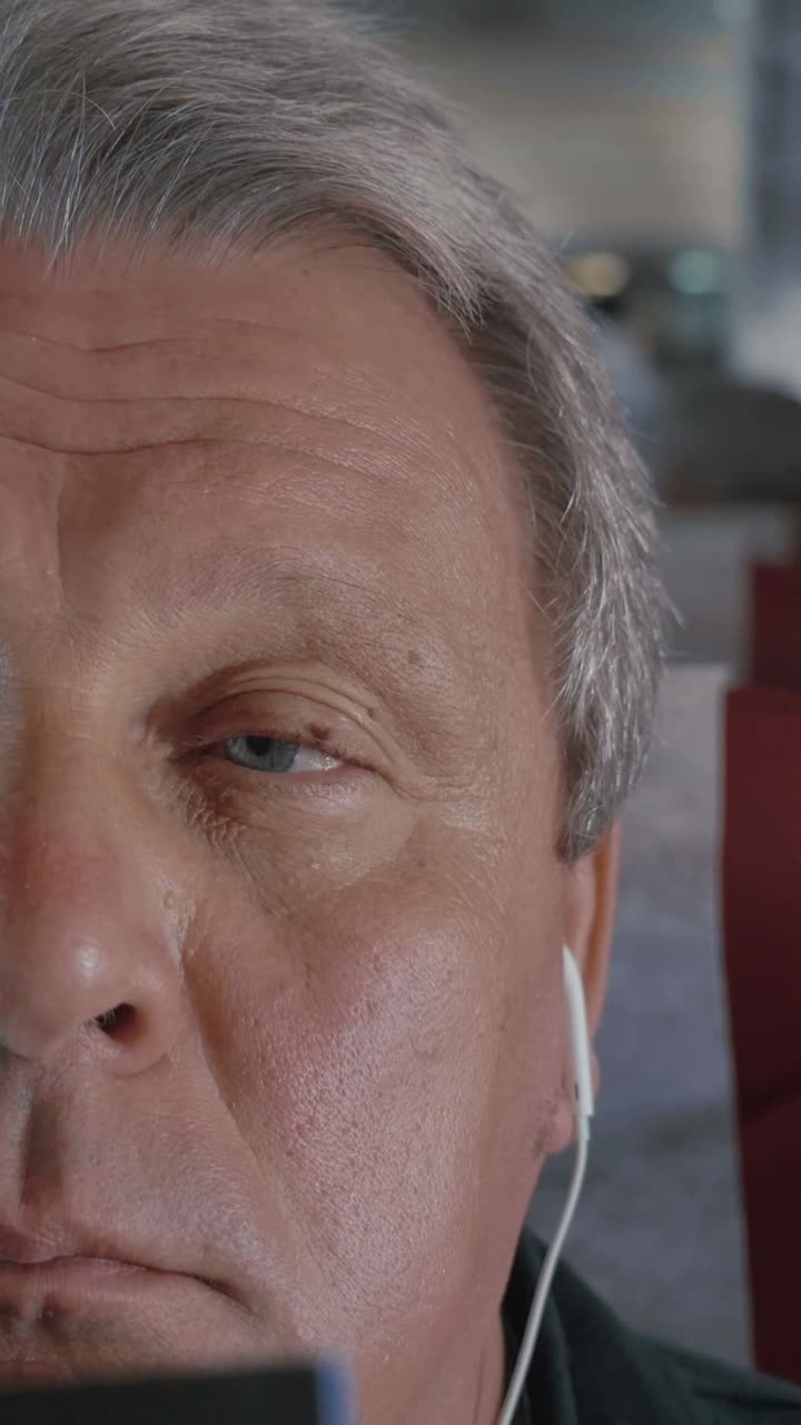 Close up of a man's face with earphones