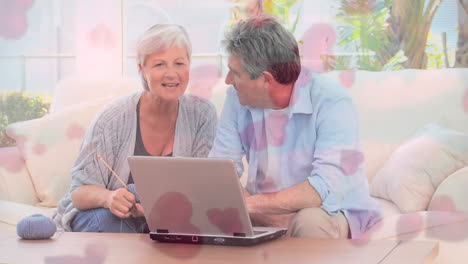 Mature-couple-interacting-on-a-sofa-with-hearts-flying-on-the-foreground