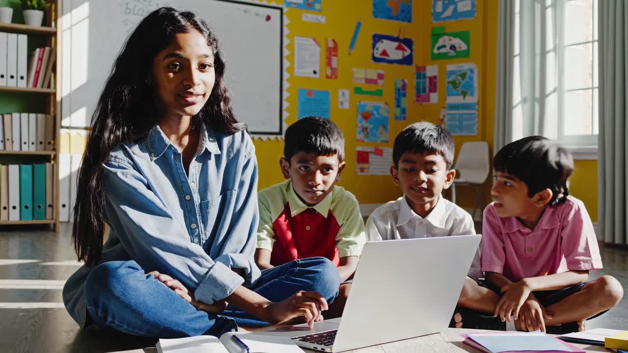 Teacher and Students Using Laptop in Classroom