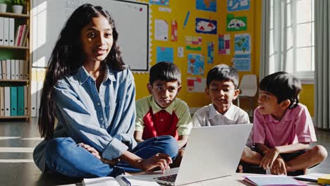 teacher and students using laptop in classroom