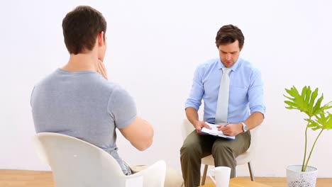 physiotherapist talking with patient with neck pain