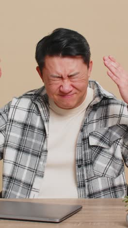 man using laptop surprised by bad news fortune loss game fail lottery results sitting at table