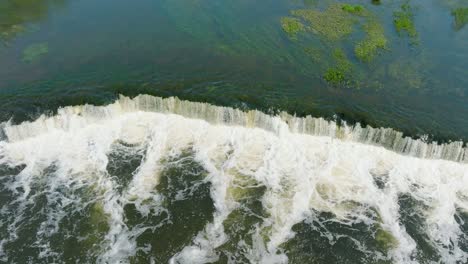 aerial establishing view of vimba fish , kuldiga, sunny spring day, birdseye drone shot moving forward