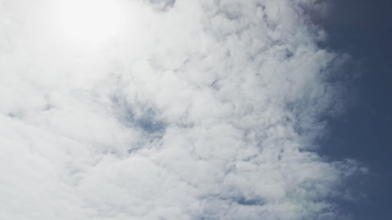 Low angle of blue sky with sunshine and clouds