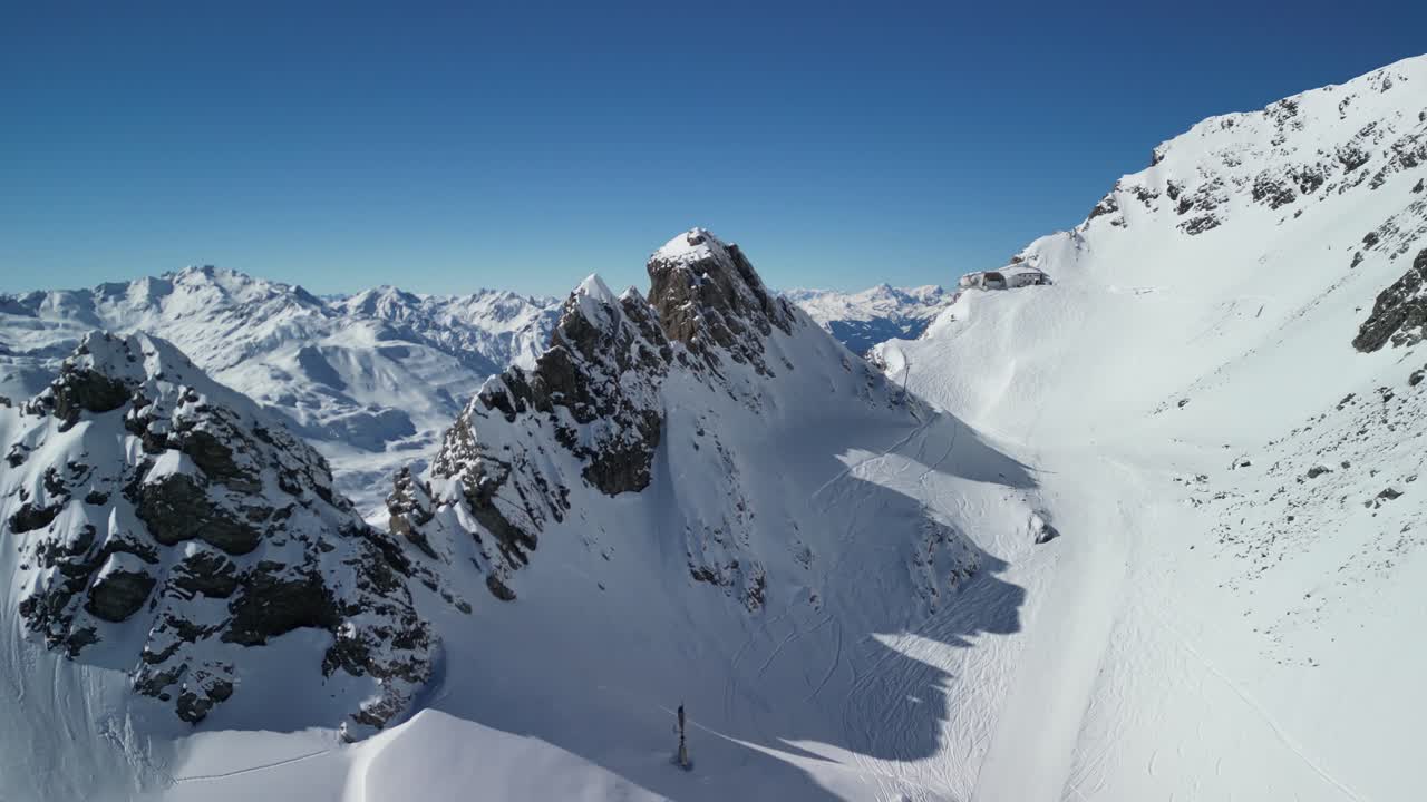 Epic drone footage of snow capped peaks in Austrian ski resort of St Anton On a beautiful sunny clear blue day
