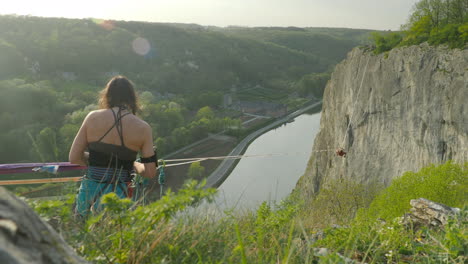 athlete preparing to do high line slack line over cliff in mountains