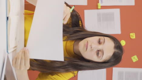 Vertical-video-of-Girl-child-studying-on-laptop.