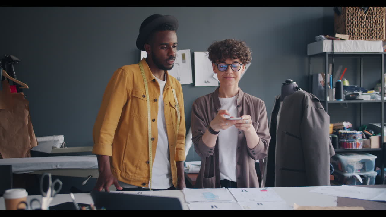 Fashion Designers Collaborating on Mobile Phone