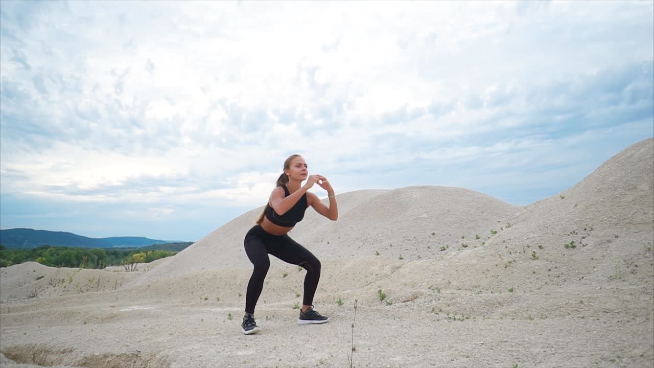 Woman Doing Squats in a Desert Landscape