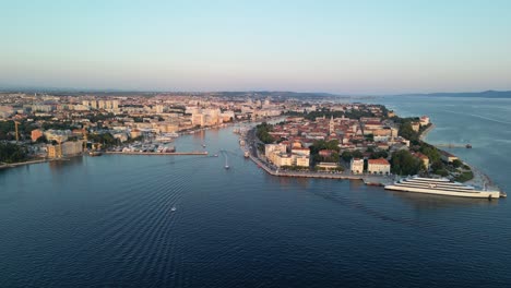 City-of-Zadar-in-the-evening-a-static-aerial-footage-with-cruise-ship,-marina,-and-city-buildings,-summer-in-Croatia