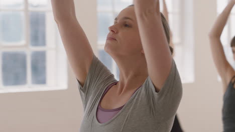 portrait young pregnant caucasian woman in yoga class practicing warrior pose enjoying healthy lifestyle group exercising in fitness studio