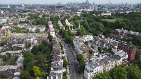 primrose hill london , rising drone aerial reveal city skyline in distance