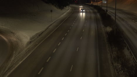 Overview-of-car-movement-on-a-two-lane-road-in-the-middle-of-the-city-at-night-time