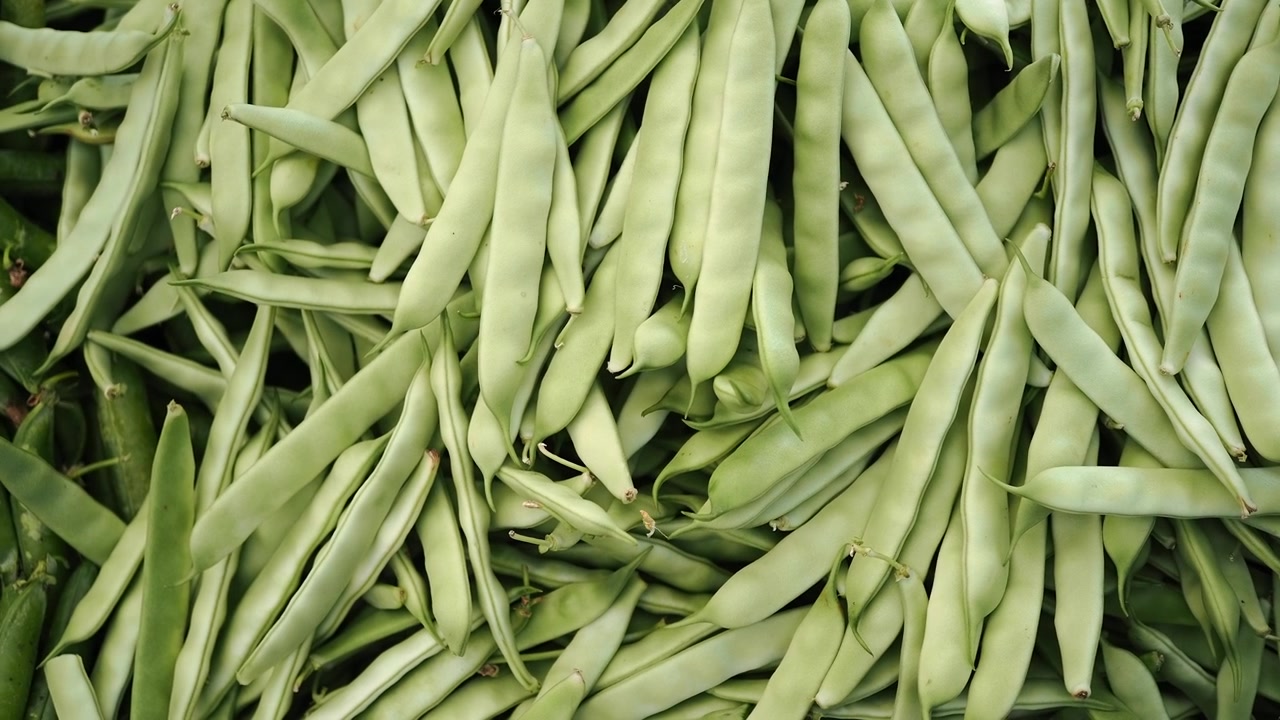Fresh Green Beans and Peas Displayed at Market