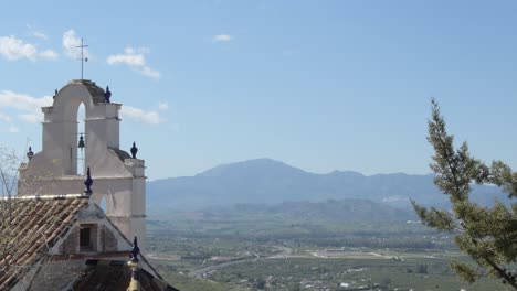 bell tower of a ancient hermitage looking to the mountains, cártama, spain