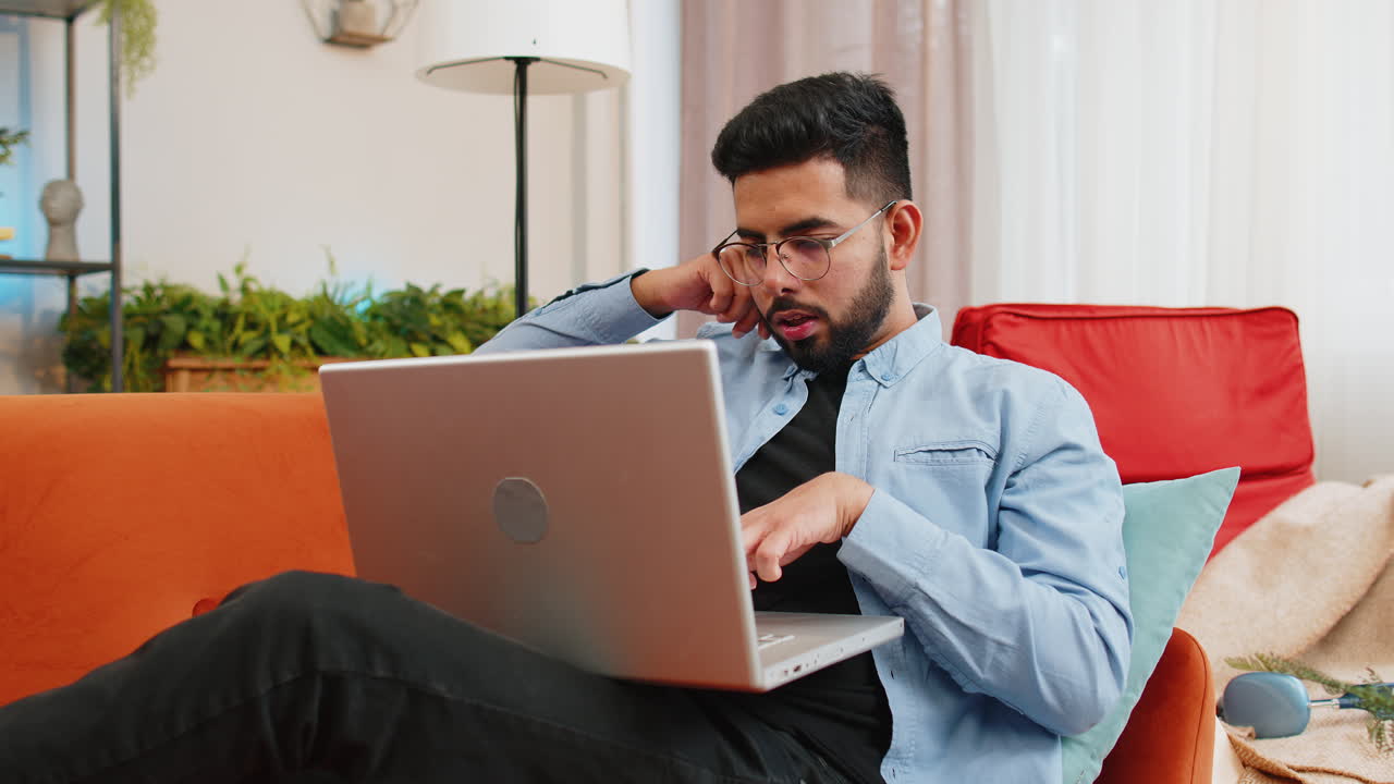 Happy indian man using laptop receive good news shocked by victory celebrate lottery jackpot victory