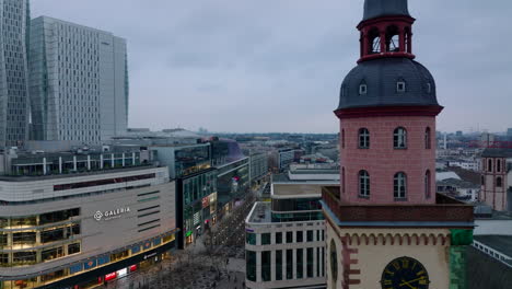 Fly-around-colour-tower-of-St.-Catherines-Church.-Modern-buildings-in-city-centre-and-Zeil-shopping-street-in-background.-Frankfurt-am-Main,-Germany